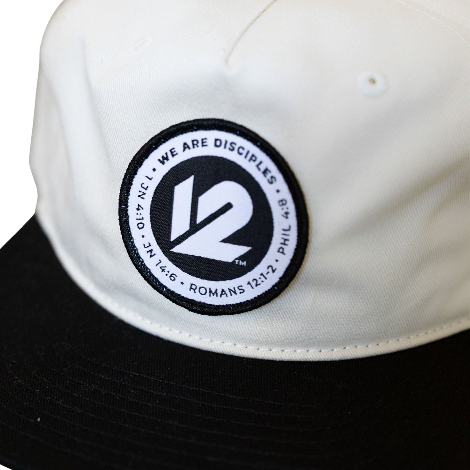 We are Disciples logo on 5 panel unstructured hat in vintage white and black